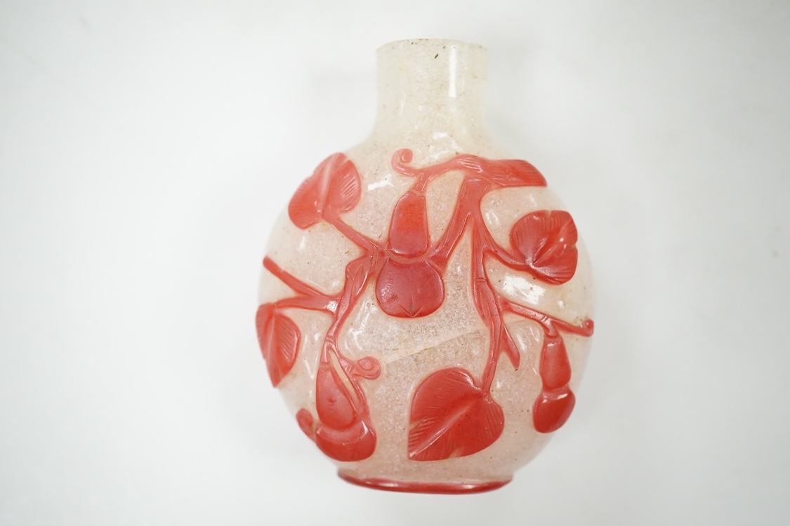 A Chinese cinnabar lacquer snuff bottle, a glass overlay snuff bottle and an underglaze copper red snuff bottle-9cm high (3)